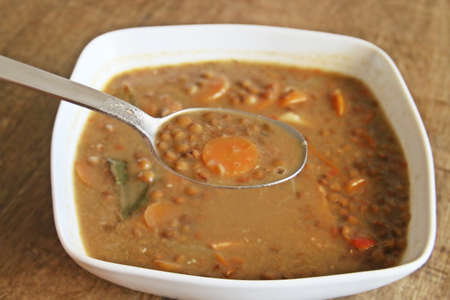 Still life with bowl of lentil stew served and ready to eat.の写真素材