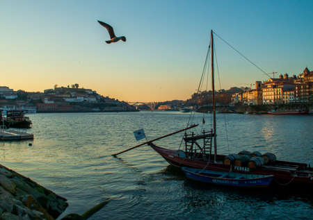 Porto / Portugal Douro river and rabelo boats in Vila Nova de Gaia at sunset. Arr?bida bridge that connects Vila Nova de Gaia with Porto at the background.のeditorial素材