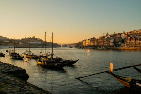 Porto / Portugal Douro river and rabelo boats in Vila Nova de Gaia at sunset. Arr?bida bridge that connects Vila Nova de Gaia with Porto at the background.のeditorial素材