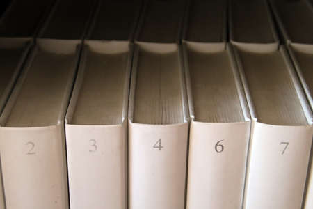 Numbered books in a bookshelf.