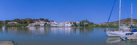 Alcoutim / Portugal; 08/19/2018. Panoramic view of the border town of Alcoutim (Portugal) from the Sanl?car de Guadiana marina in Spain.のeditorial素材
