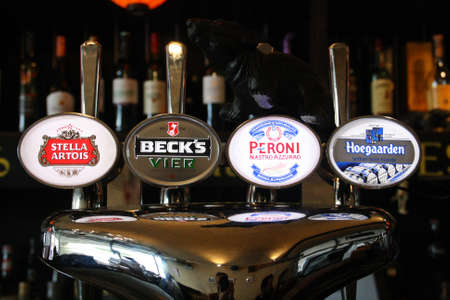 London / United Kingdom; 10/18/2013. Four beer tap in a London pub. International brands.のeditorial素材