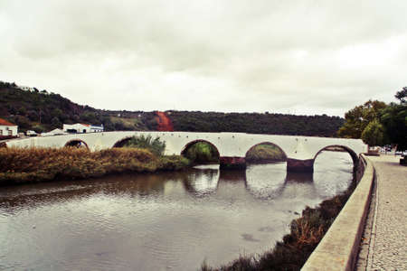 Roman Bridge of Silves over the river Arade, Faro district, Algarve, Portugal.の写真素材