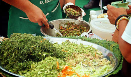 Buyer in a street market, thai food to take away in Bangkok, Thailand.