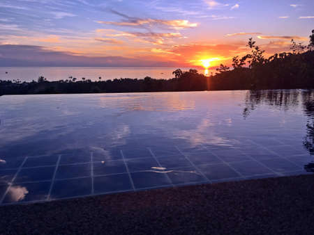 Sunset from the pool of a luxurious cabana overlooking the sea. Koh Tao island, Thailand.