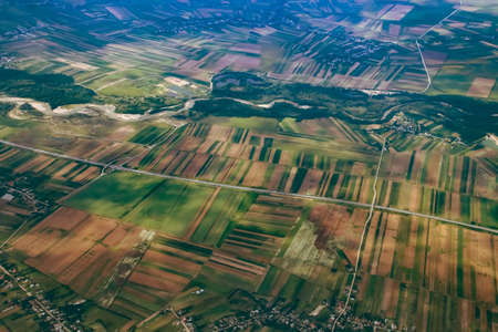 Highway A1 and the Arges river in the vicinity of the town of Salcioara, Romania. Aerial photograph taken from a commercial airplane before landing.の写真素材