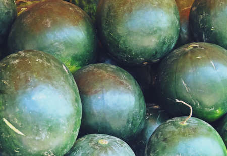 Watermelons displayed for sale at a vegetable stall. Close-up of watermelons for sale in the streets of Tulcea, Romania.の写真素材