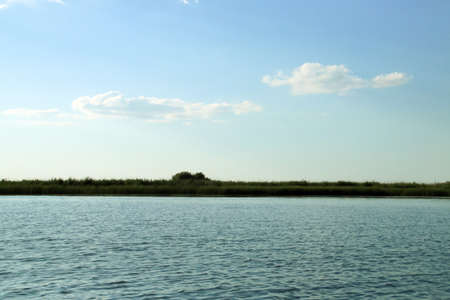 Danube delta wetland landscape in Romania. Landscape composed of the water of the lagoon and the...