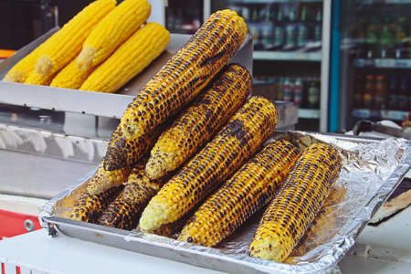 Roasted corn cobs displayed for sale. Sweet corncobs at a Mamaia take away stall in Constanta,...