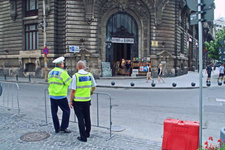 Bucharest / Romania; 07/07/2018. Bucharest local policemen controlling the entrance to a pedestrian...