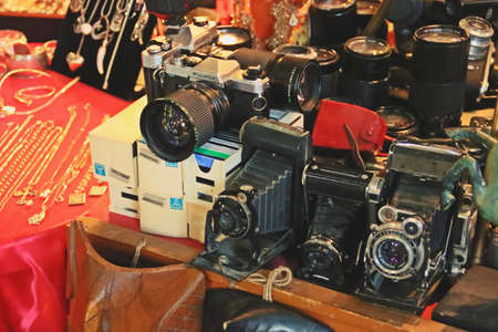 Bucharest / Romania; 07/07/2018. Old photo cameras under a warm light. Antiques displayed for sale...
