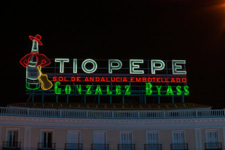 Madrid, Spain; 12 02 2020. The famous luminous sign of the Jerez wines and brandies "TÃ­o Pepe" in Sol square at night. Poster located on the building number 11 of the square since 2014.のeditorial素材