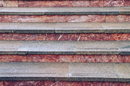 Stone steps in an underpass in Bucharest, Romania. Granite tile and red rock staircase.の写真素材