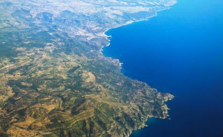 Coasts of Sardinia, mouth of the Temo river and the town of Bosa, Italy. Aerial view from the window of a commercial flight.の写真素材