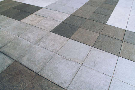 Tiled floor in a street in Madrid, Spain. Square and gray tile flooring in perspective.の写真素材