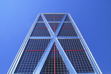Madrid, Spain. 10 16 2018. Bankia Tower one of the two KIO Towers or Gate of Europe in the famous street, Paseo de la Castellana in Madrid. Leaning office tower belonging to Bankia bank.のeditorial素材