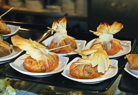 Tapas displayed in a bar to be sold. Different types of typical Spanish aperitif.