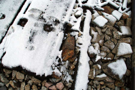 Wooden path on the old train track at Gascones-Buitrago station with some snowflakes. Rural landscape after the first autumn snowfall in this forgotten station in the community of Madrid, Spain.の写真素材