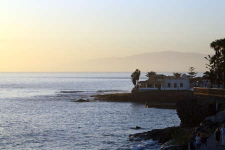 Sunset on La Caleta beach with Gomera Island in the background. La Caleta beach in the south of the...