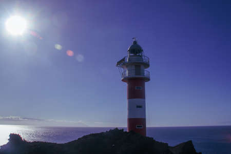 Cape Teno lighthouse, built in 1893 on the island of Tenerife. Lighthouse located in the southwest of the island with the Atlantic Ocean in the background.の写真素材