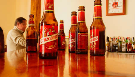 SanlÃºcar de Guadiana, Spain; 04 22 2017. Cold Cruzcampo bottled beer on the bar of a restaurant of Spain. Cruzcampo beer, spanish trademark.のeditorial素材