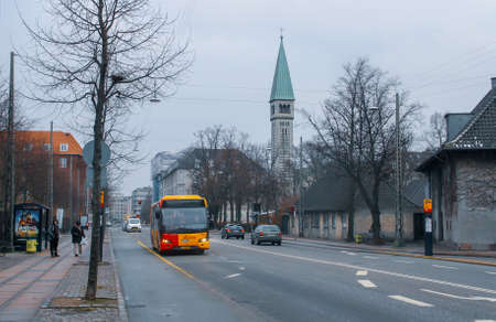 Copenhagen, Denmark; 02 14 2016. Yellow bus driving on Enghavevej street on a cloudy winter day....