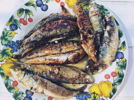 Tray of sardines (Sardina pilchardus) roasted with charcoal on the barbecue, Andalusia, Spain. They are a nutrient-rich, small, oily fish widely consumed and source of omega-3 fatty acids.の写真素材