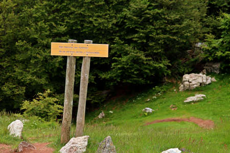 Borce, France; 06 15 2016. Warning sign in the Pyrenees. Parc National des PyrÃ©nÃ©es; National Park of the Pyrenees. Dogs and motorcycles are not allowed; Dogs and motorcycles are not allowed.のeditorial素材