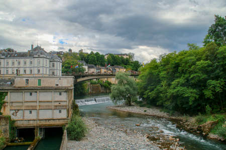 The river Aspe in Oloron-Sainte-Marie, France. Cityscape of the banks of the river that runs through the city.の写真素材
