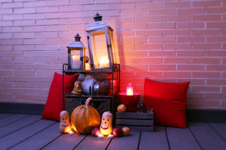 Halloween. Beautiful still life with pumpkins and old lanterns illuminated with candles.の写真素材