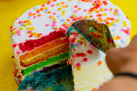 Delicious and fluffy rainbow cake. A colorful cake to share in parties.の写真素材
