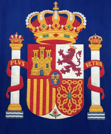 Madrid, Spain. 10 25 2018. National coat of arms of the kingdom of Spain embroidered on blue fabric. Coat of arms located at the entrance to a government building in Madrid.のeditorial素材