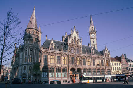 Ghent, Belgium; 04 28 2016. Old post office building and tram from Korenmarkt (English: Wheat Market), a city square in the historic center. Building built with a beautiful Gothic architecture.のeditorial素材