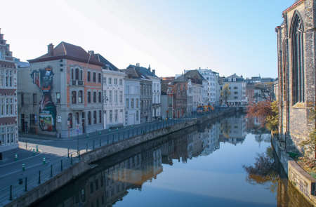 Ghent, Belgium; 04 28 2016. Predikherenlei street and the Lys river in Ghent. Image of the historic facades of the buildings built right on the river bank.のeditorial素材