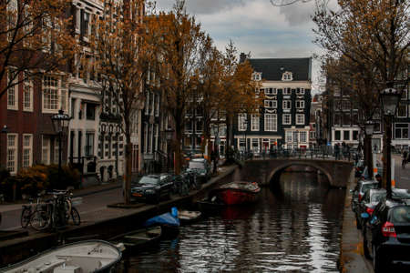 Amsterdam, Holland; 04 30 2016. Canal of Blauwburgwal street in Amsterdam. The typical Amsterdam canal lined with buildings and the narrow streets on its banks.のeditorial素材