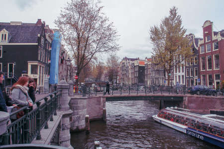 Amsterdam,Holland; 04 30 2016. Bridge over Leidsgracht canal in Amsterdam. Tourists visiting the...