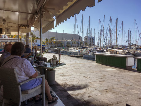 Puerto Mogan, Spain; 04 28 2018. Tourists having breakfast in the terrace of a bar in the harbor of Puerto MogÃ¡n in Gran Canaria Island.のeditorial素材