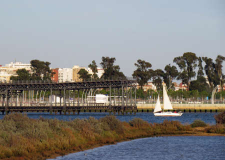 Old wharf of the "Rio Tinto Company Limited" from the marshes of the Marismas del Odiel Natural Park in Huelva, Spain. Mineral loading dock in the port of Huelva city.の写真素材