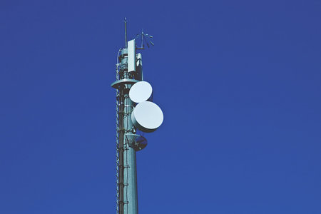 Mobile phone repeater antenna with clear sky in the background. Mobile phone tower located near the A5 motorway in Toledo, Spain.の写真素材
