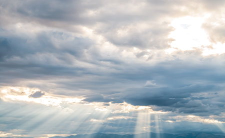 Cloudy sky with sun rays and rays of light. nature backgroundの写真素材