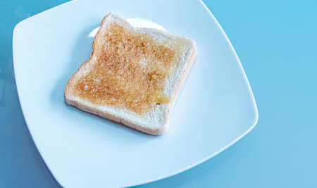 Toast bread with jam on blue background,Healthy breakfast.の写真素材