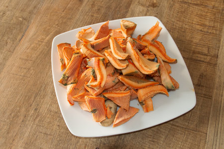Dish of fresh and washed chopped mushrooms. Dish of Lactarius deliciosus, delicious milk cap, saffron milk cap or red pine mushroom ready to be cooked. Madrid, Spain.の写真素材