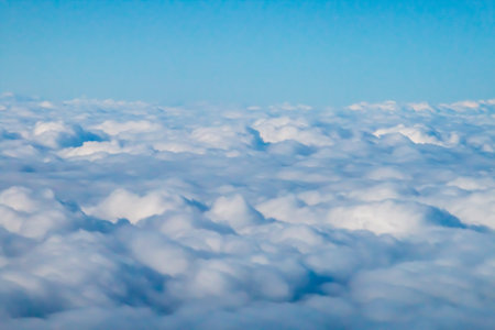 Blue sky and white clouds. View from the window of an airplane.の写真素材