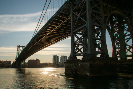 Silhouette and structure of the Williamsburg Bridge. View of the Williamsburg neighborhood in...