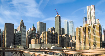Skyscrapers of New York's financial district from the Brooklyn Bridge. Panoramic view of the city skyline and its most iconic skyscrapers from the bridge over the East River.の写真素材