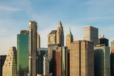 Skyscrapers of New York's financial district from the Brooklyn Bridge. Panoramic view of the city skyline and its most iconic skyscrapers from the bridge over the East River.の写真素材