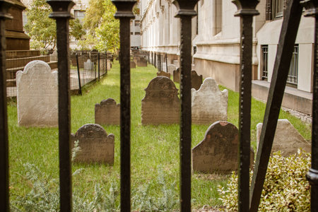 Old tombstones in the cemetery next to the church at 89 Broadway. Cemetery surrounded by the skyscrapers of the Financial District in Lower Manhattan, New York, USA. 2019.の写真素材