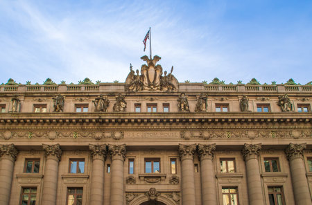 Facade decorated with columns and statues, and topped with the US flag. NYCの写真素材