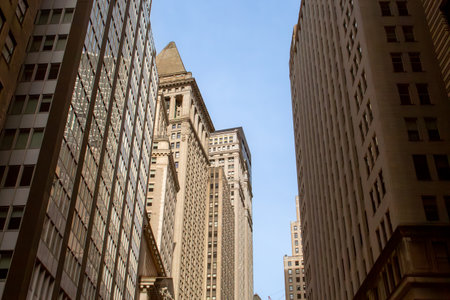 Cityscape with skyscrapers of New York's financial district seen from below. Skyscrapers next to The New York Stock Exchange, intersection of Broad Street and Wall Street, USA.の写真素材