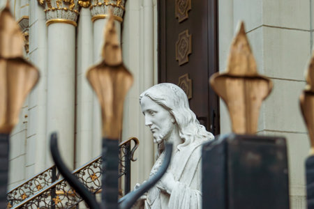 Sculpture of Jesus at the entrance of the church in New York, USA. Face of the religious sculpture between the bars of the church entrance.の写真素材